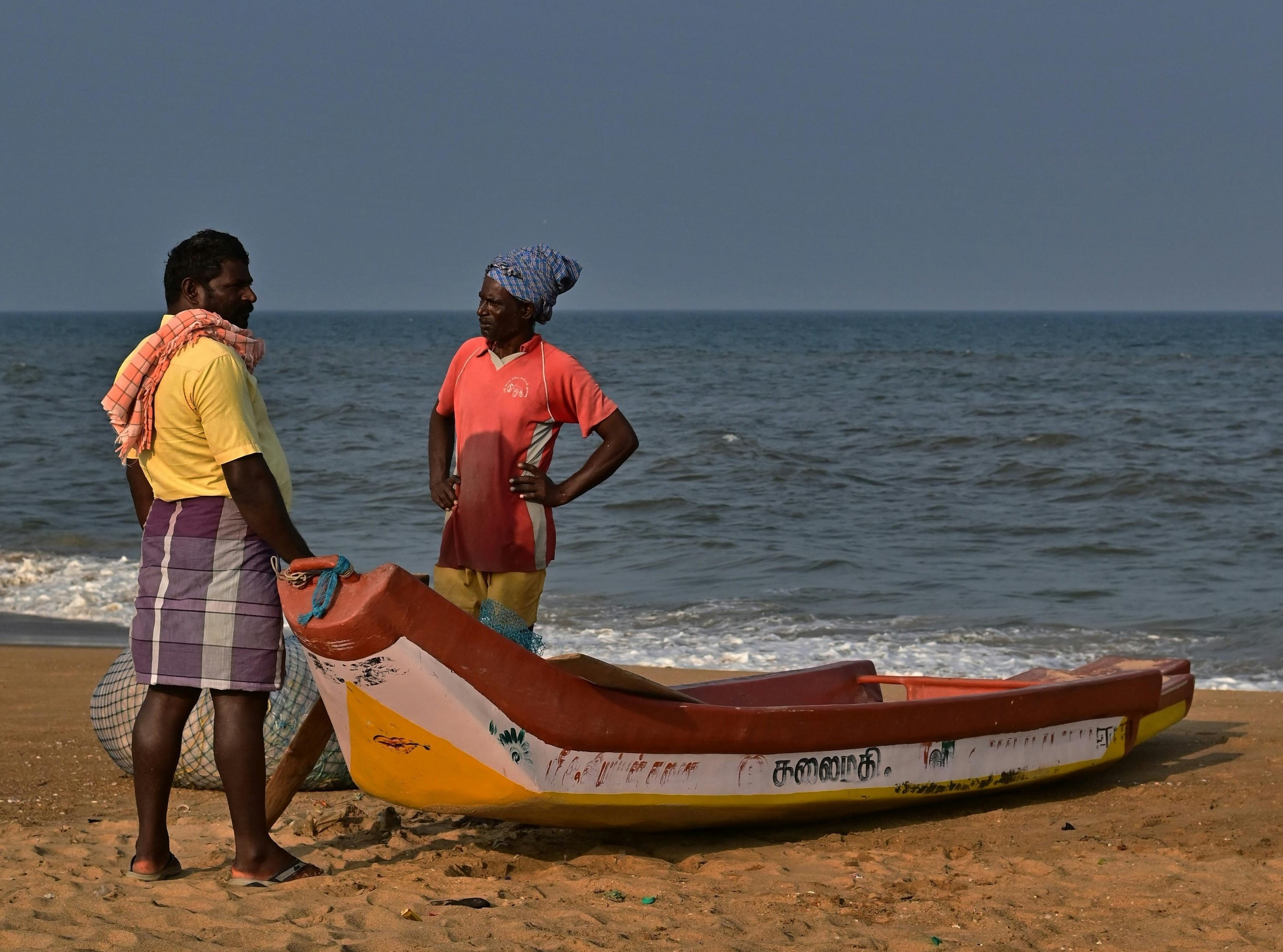Golden sunrise at Marina Beach with fishing boats in Tamil Nadu