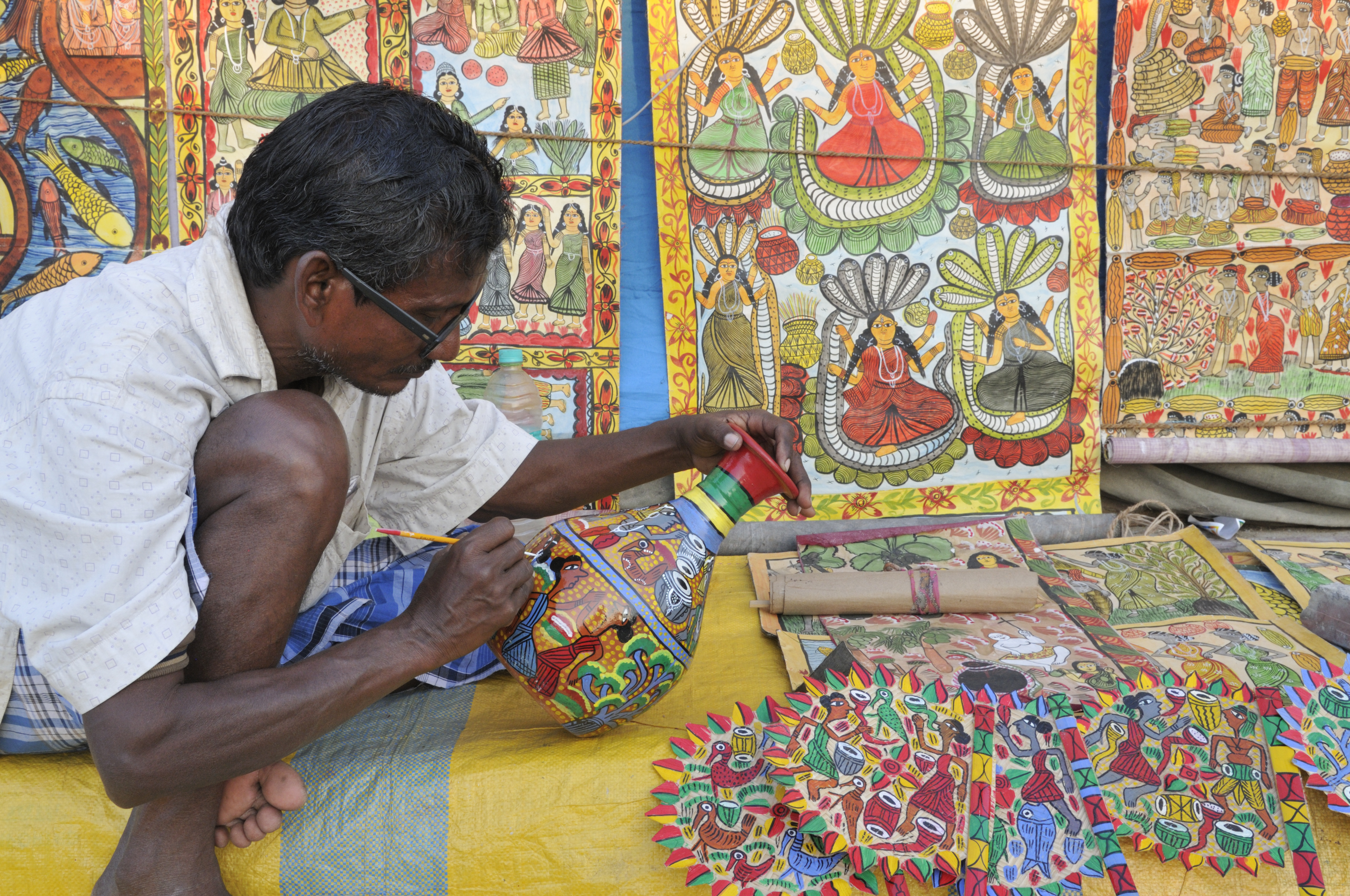 Traditional Tamil artisans creating bronze statues, silk sarees, and colorful Athangudi tiles